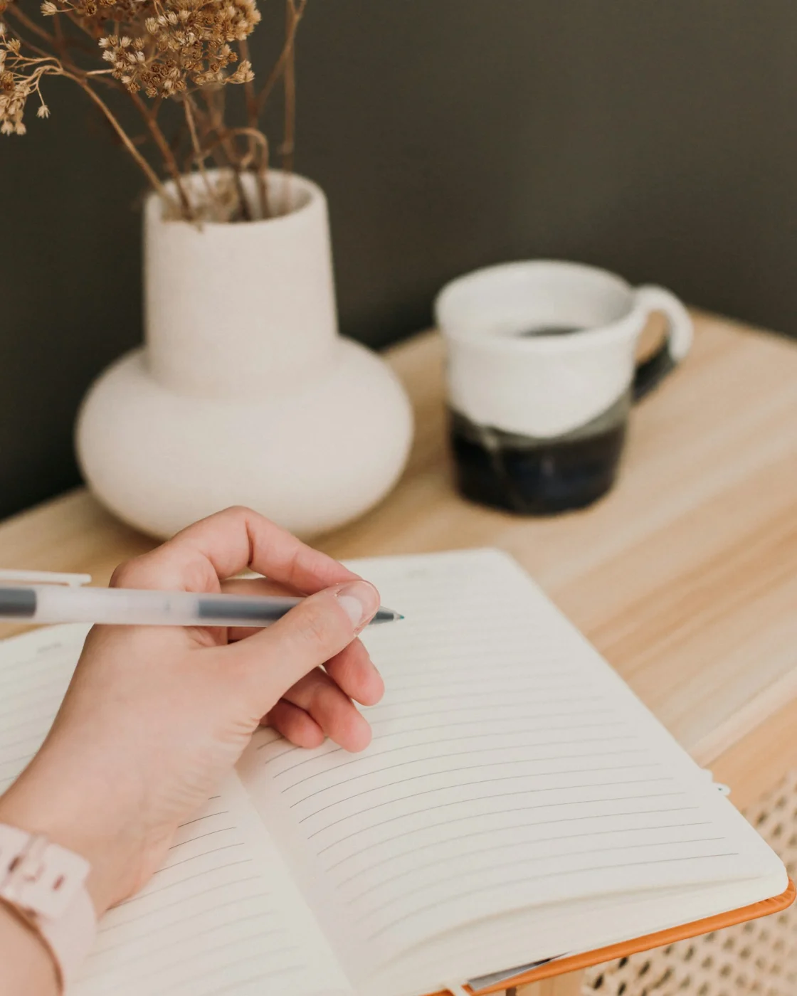A person writing notes with a pen