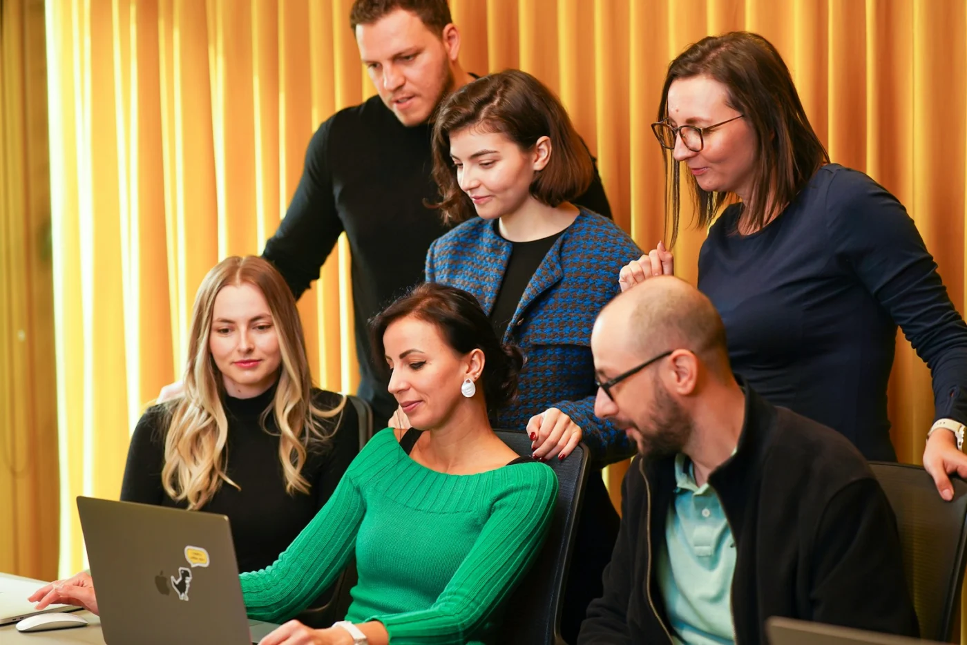 Colleagues reviewing an account together on a laptop