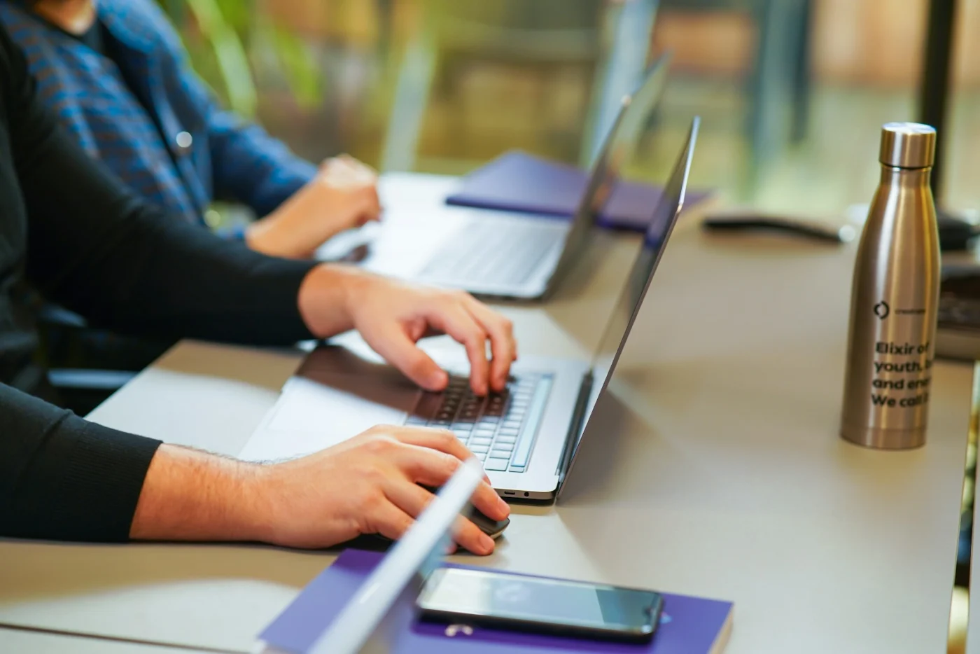 A marketer working on a laptop in a meeting room