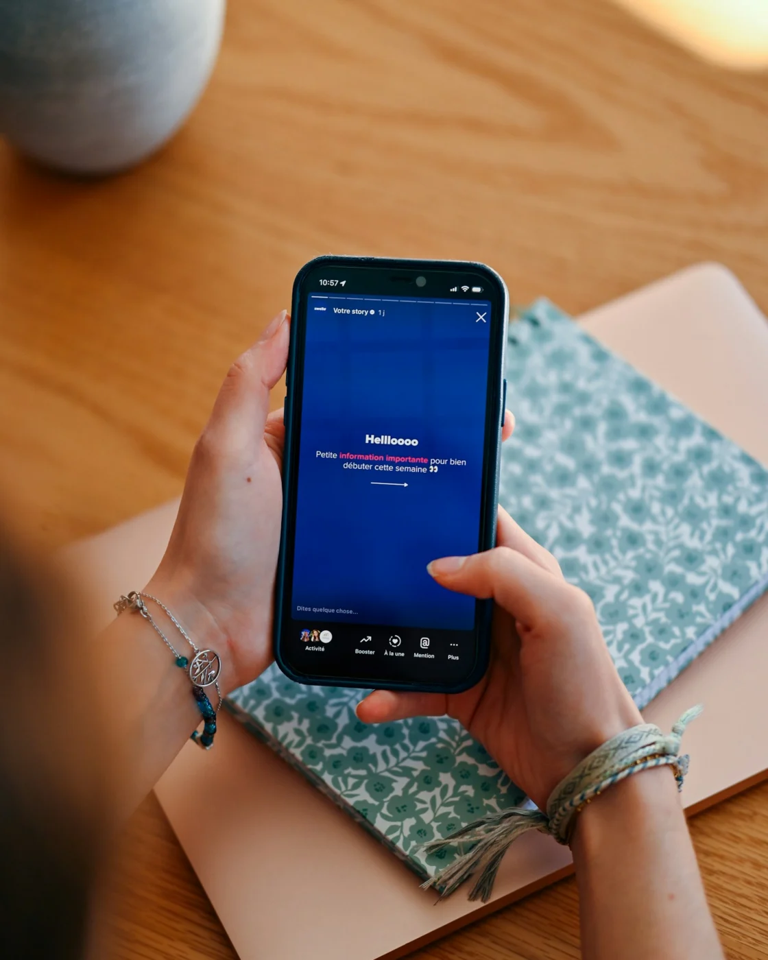Hands holding a smartphone showing a social media feed
