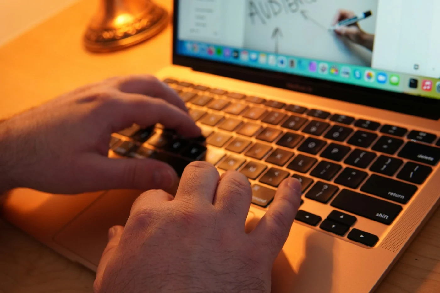 Hands typing on a laptop while editing a website