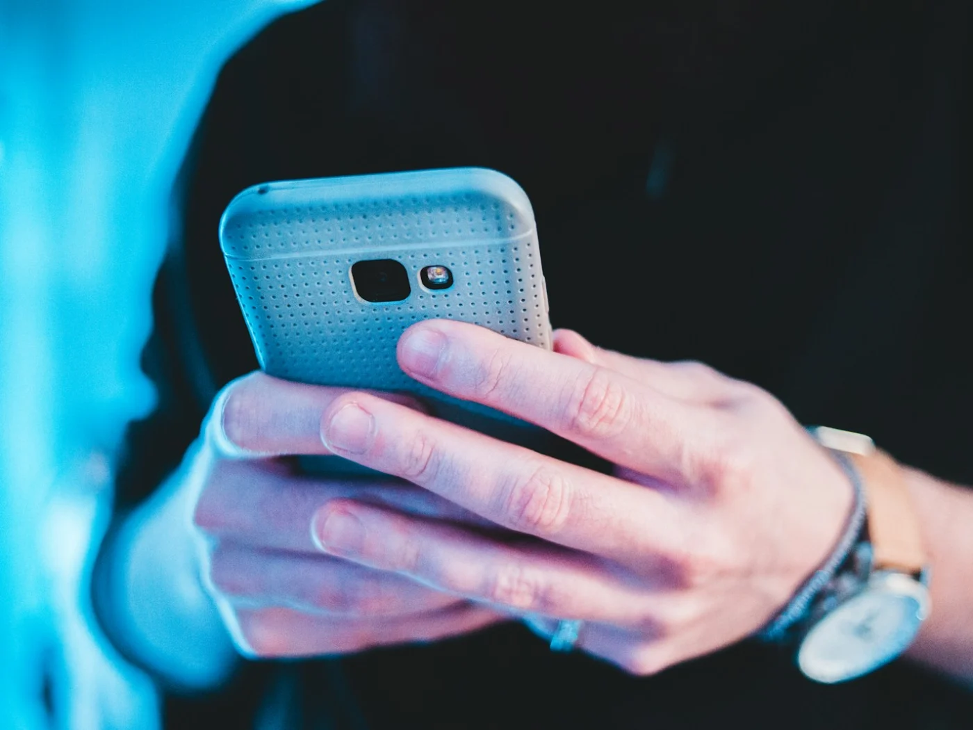 A smartphone held in one hand showing vertical video